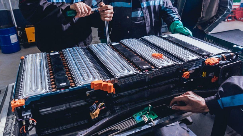 Technician sorting battery cells for second-life and recycling